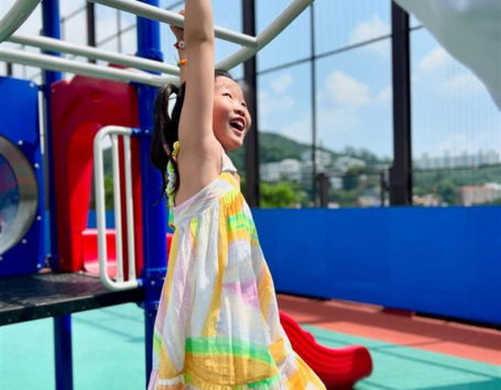 Smiling girl on playground.