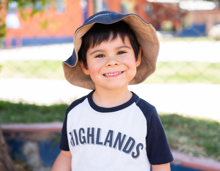 Smiling boy in a hat.